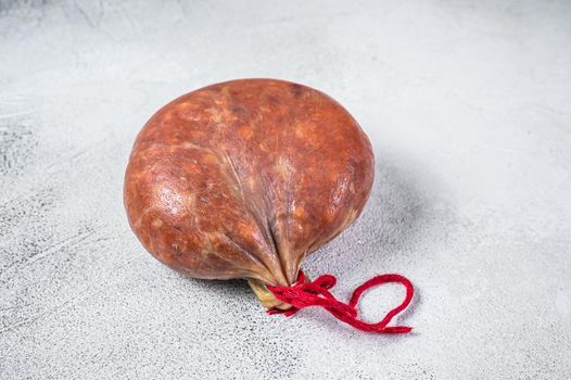 Sobrassada cured meat sausage from ground pork, paprika and spices. White background. Top view.