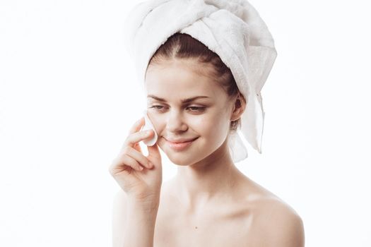 woman with cotton pads in her hands clean skin bare shoulders after shower. High quality photo