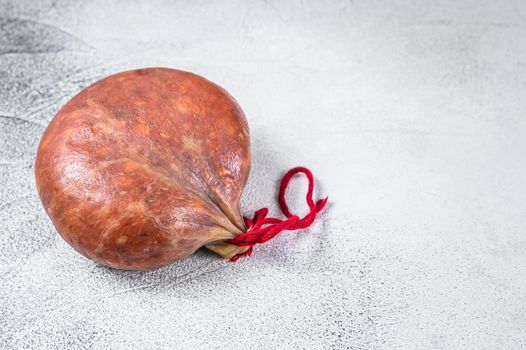 Sobrassada cured meat sausage from ground pork, paprika and spices. White background. Top view. Copy space.