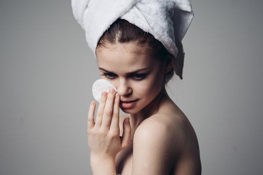 woman with cotton pads in her hands clean skin bare shoulders after shower. High quality photo