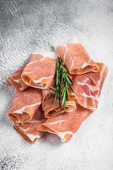 Italian prosciutto crudo parma ham on a table. White background. Top View.