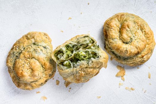 Spinach and feta cheese Twist greek Pie puff. White background. Top view.