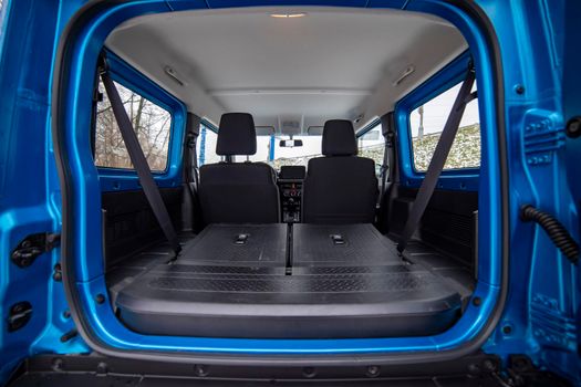 open car trunk with seats folded into a flat flor of suv crossover