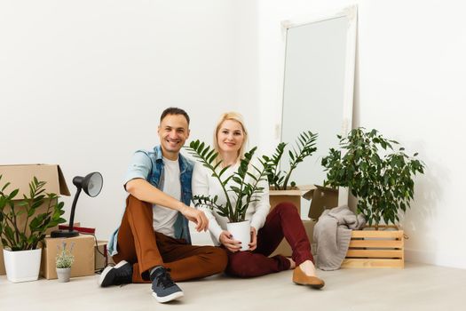 Family unpacking cardboard boxes at new home