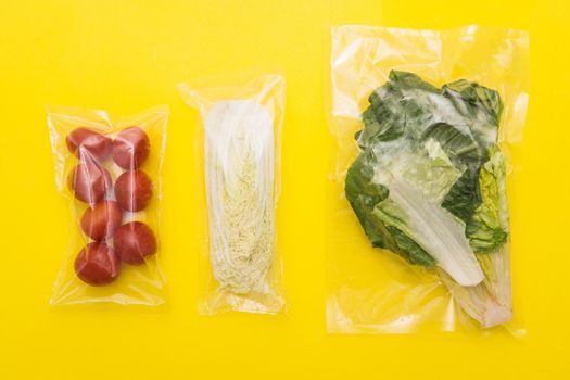 Salad dinner set: lettuce, tomatoes, peking cabbage, A set for delivering food for dinner on a yellow background. I cook at home. Ingredients for veggie vegetable salad.