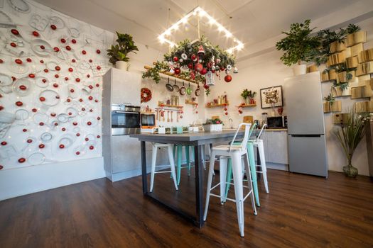 interior of a cozy modern spacious kitchen for a large family, decorated for the New Year celebration...