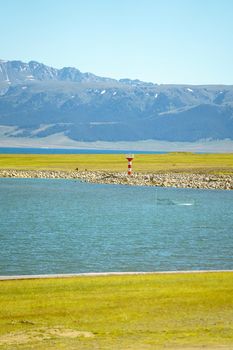 Road and lighthouses on the lake. Shot in Sayram Lake, Xinjiang, China.