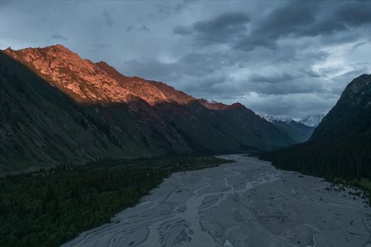 River and mountains at sunset. Shot in Xinjiang, China.