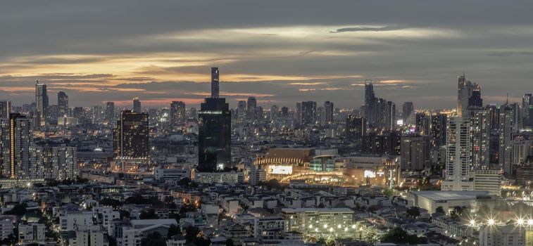 Bangkok, Thailand - Jun 05, 2021: Panorama shot of sunset at Bangkok city skyline. Beautiful scenery view of Skyscraper at night, Selective focus.