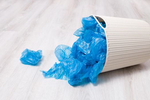 a lot of blue shoe covers in a dropped plastic basket, new or used shoe covers, dirt protection