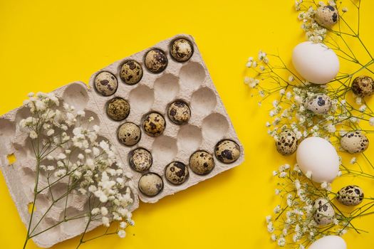 Easter background, various eggs on a yellow background, decorated with natural botanical elements, flat lay, view from above, empty space for text