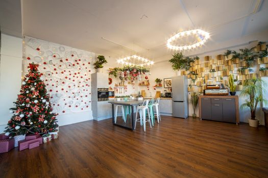 interior of a cozy modern spacious kitchen for a large family, decorated for the New Year celebration...