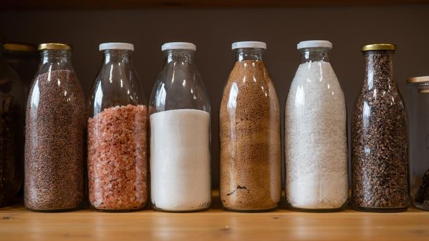 Glass jars with cereals in an eco friendly store. The concept of a grocery store without plastic disposable packaging.