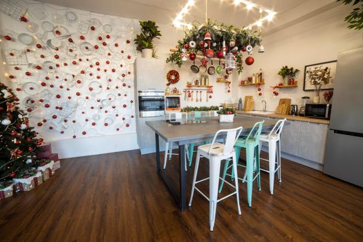 interior of a cozy modern spacious kitchen for a large family, decorated for the New Year celebration...