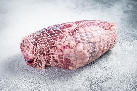 Boneless Leg of Lamb meat on butcher table. White background. Top view.