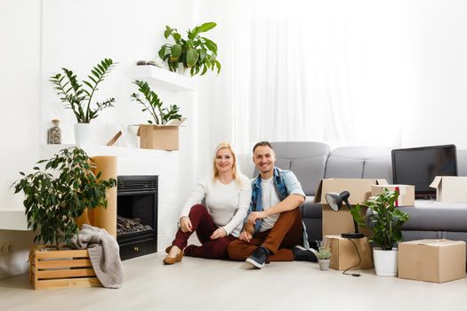 Family unpacking cardboard boxes at new home