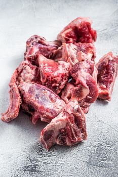 Raw lamb meat stew cuts with bone. White background. Top view.