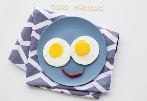 cheerful breakfast, two eggs on a plate, the inscription Good Morning