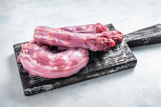 Raw Turkey or chicken necks meat on a wooden board with thyme. White background. Top View.
