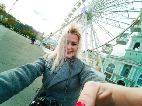 Stylish woman posing near ferris wheel