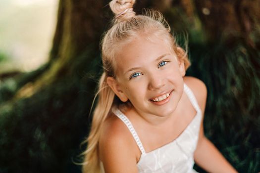 Summer portrait of a happy little girl on the island of Mauritius.beautiful smile, summer white dress