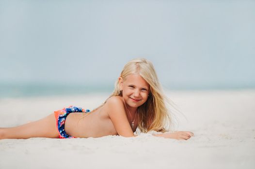 Adorable little girl at beach during summer vacation.