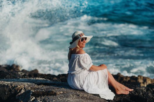 Smiling Beautiful Woman on the Beach In a Straw Hat on the island of Zakynthos.A girl in a white dress at sunset on Zakynthos island, Greece