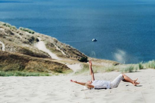 a child has fun in the sand dunes on the beach in Nida.Lithuania.