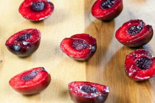 cut into half a juicy cherry lying on the board. in the pulp of berries bones were extracted