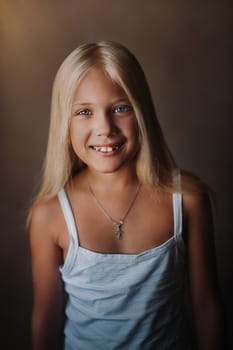 Portrait of a beautiful blonde girl in her apartment. With long loose hair smiling.