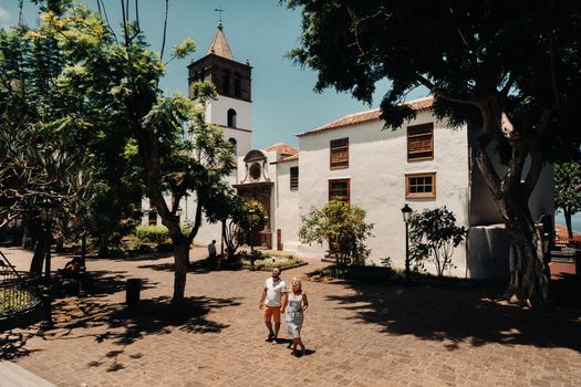 beautiful couple with glasses in the old town in the Canary Islands, Lovers on the island of Tenerife in the city of Icod de Los Vinos.Spain.