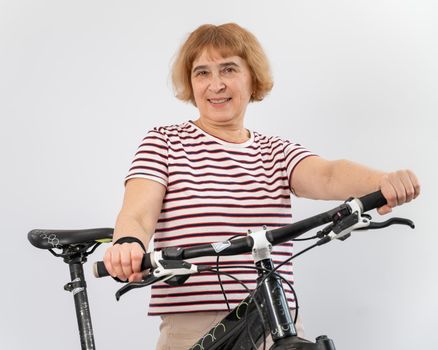 Elderly woman on a bicycle on a white background