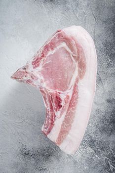 Raw whole rack of pork loin with ribs on kitchen table. White background. Top view.