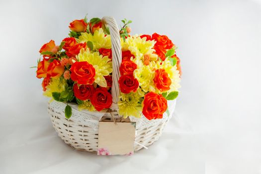 white basket with scarlet roses and yellow chrysanthemums. beautiful gift. flovers for cut out white background