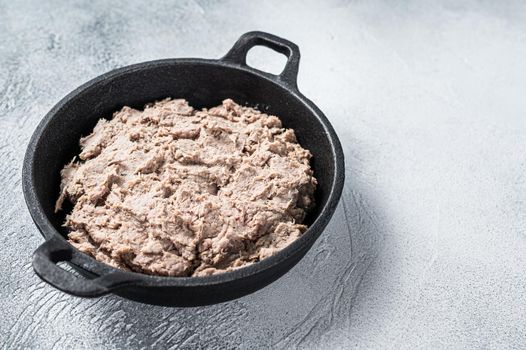 Duck Rillettes de Canard in a pan. White background. Top View. Copy space.