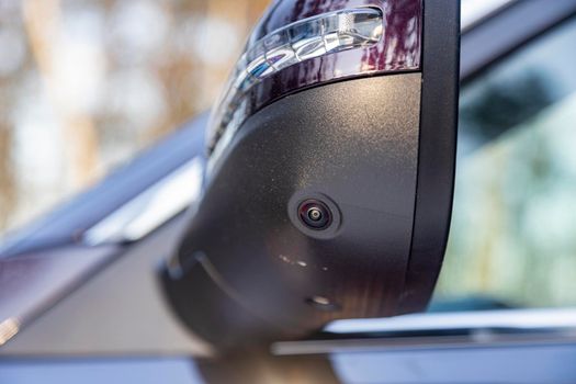 closeup of a surround view camera in the side mirror of a modern car rear view. camera of parking assuist