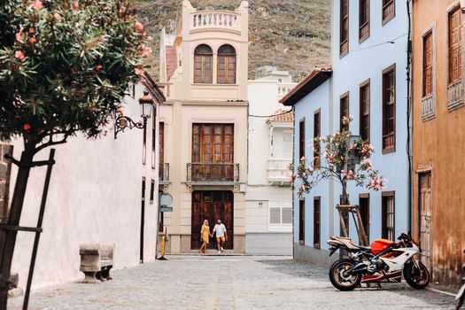 a modern married couple of lovers strolling in the old town of the island of Tenerife, a couple of lovers in the city of LA Laguna.