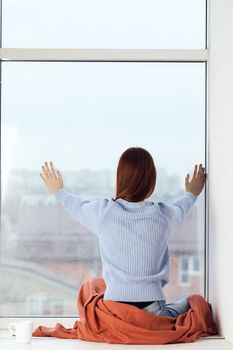 woman near the window dreamy look rest at home comfort. High quality photo