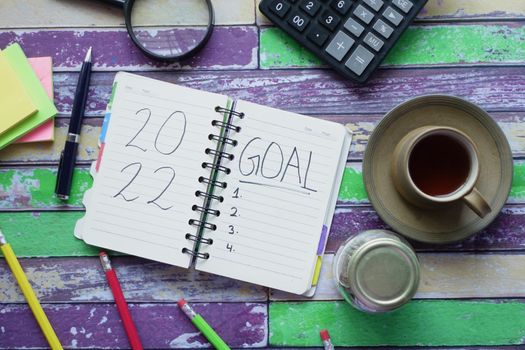 2022 new year goals on notepad on table ,