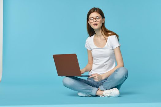 woman sitting on the floor with laptop student education online. High quality photo