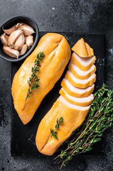 Smoked cut chicken breast fillet meat delicacy. Black background. Top view.