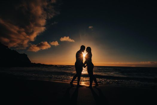 a man makes an offer with a wedding ring to his girlfriend on the sea beach. sunset romantic i said yes.