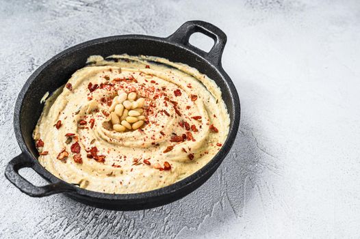 Hummus dip with chickpea in a bowl. White background. Top view. Copy space.