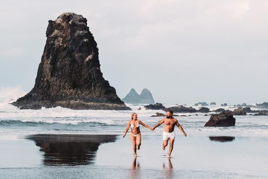 Benijo, Tenerife, Spain : Natural sand beach. Popular place for local people and tourists. Volcanic rocks billowi out of turquoise water and soft gentle waves washing the sandy shore