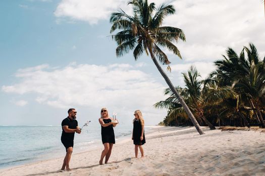 Happy beautiful family on a tropical beach celebrates the birth of their daughter.Family celebrates birthday on the island of Mauritius.