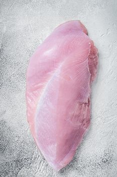 Raw whole big turkey breast fillet. White background. Top View.