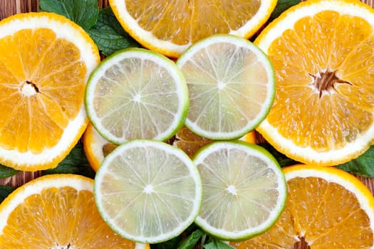 cut slices of orange and lime, lying next to each other and photographed close-up