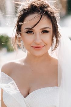 Portrait of the bride in close-up.A stunning young bride with curly hair . Wedding day. . Beautiful portrait of the bride without the groom