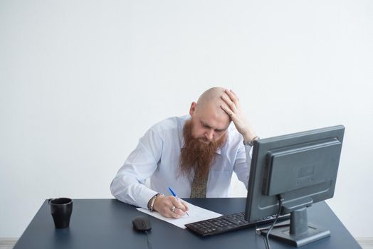 Problems for the office worker. A bald man in a white shirt sits at a desk with a computer and is stressed because of failure. A nervous breakdown