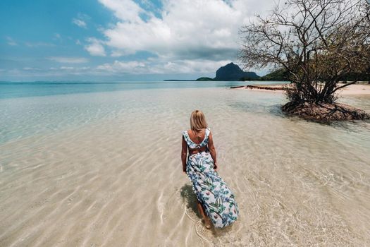Young woman in a swimsuit relaxing on a tropical beach. Tropical vacation in paradise.mauritius island.